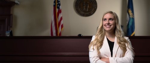 A pre-law student standing in a courtroom