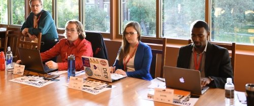 Students working a gubernatorial debate on campus