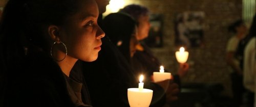 Students participate in a candlelight vigil