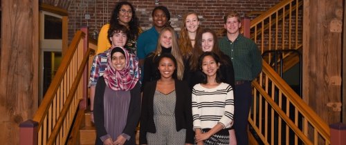 Ten students standing on stairs inside Combs warehouse for Lincoln Scholars group photo