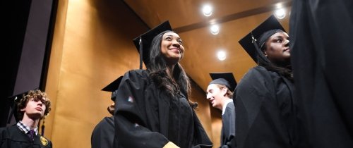 students in cap and gown at graduation