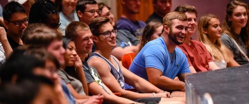 Students laughing in Newlin Hall at new student orientation