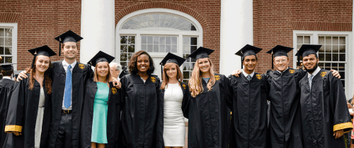 Centre graduates standing in front of Old Centre