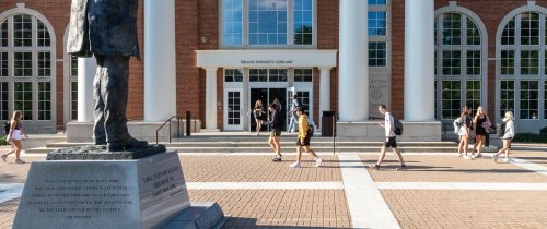 Centre students walking to class passing the library