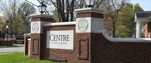 Brick entryway to campus with Centre logo