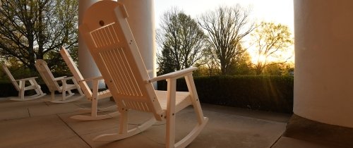 white rocking chairs on the porch of Old Centre at sunrise