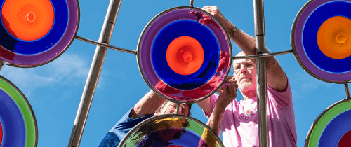 Brook Forrest White, Jr. '91 works on installing a glass disc at the Stephen Powell Memorial Sculpture. White spearheaded the installation of the memorial sculpture and garden, which was dedicated Oct. 15 during Centre College's 2022 Homecoming.