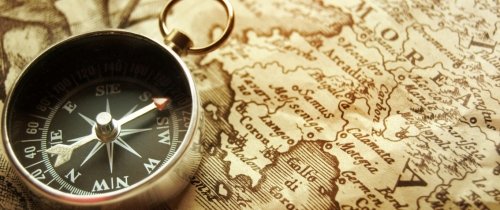 compass-page-header.jpeg Compass laying on archival world map