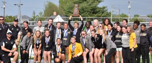 Large group of Women's Cross Country Team celebrating championship