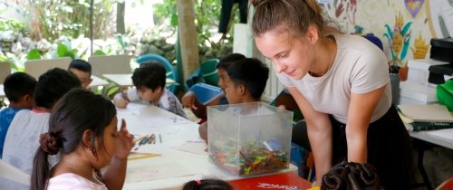 Student intern teaching children while studying abroad