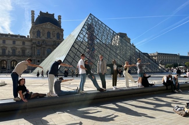 Students use their bodies to spell out Centre in front of the Louvre in Paris