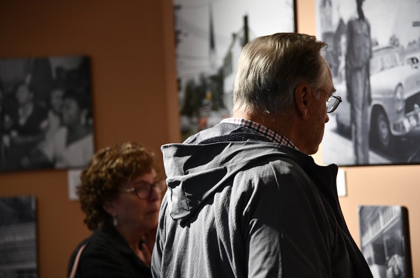 People viewing "We Were Here" exhibit