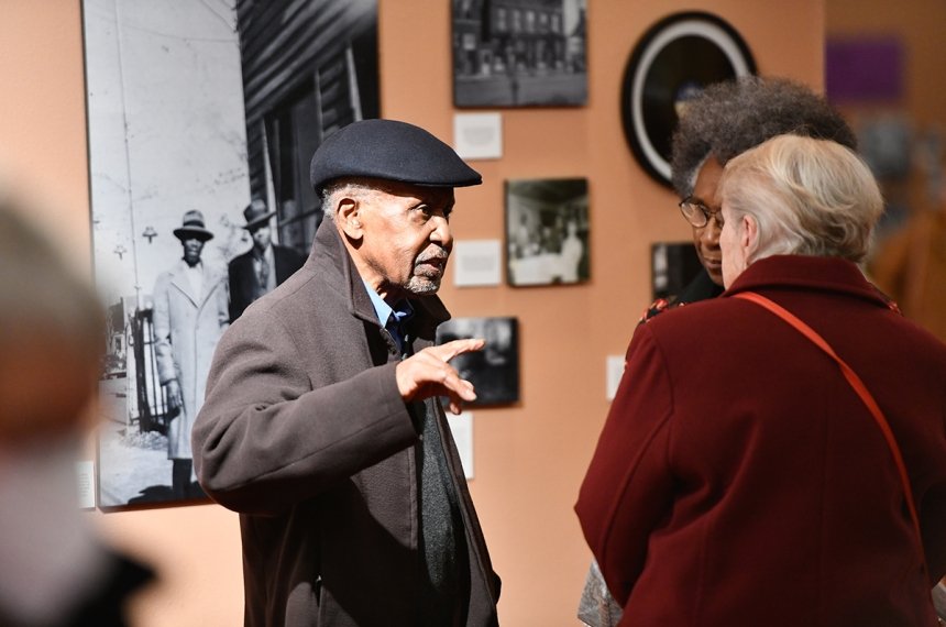 People viewing "We Were Here" exhibit