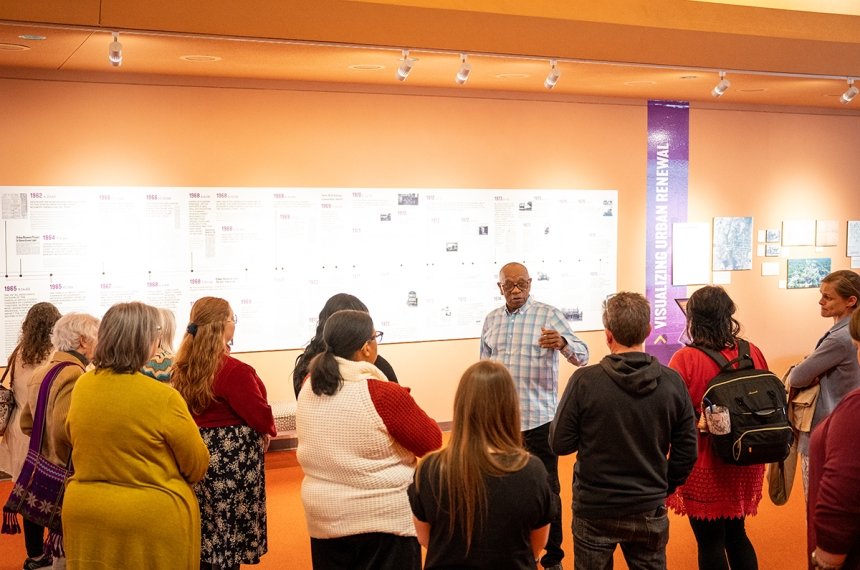 People viewing "We Were Here" exhibit