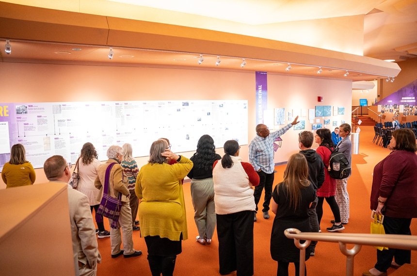 People viewing "We Were Here" exhibit