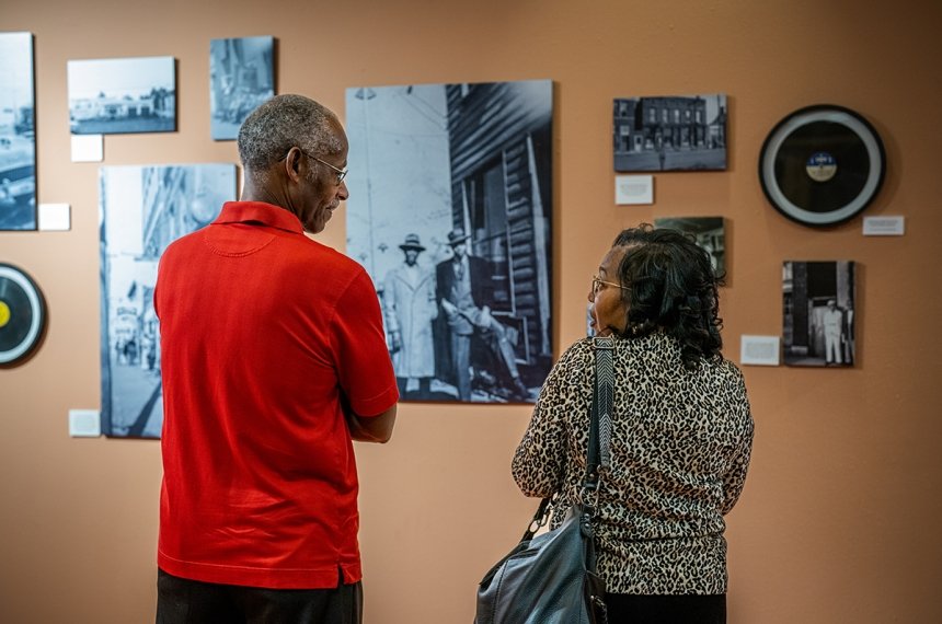 People viewing "We Were Here" exhibit
