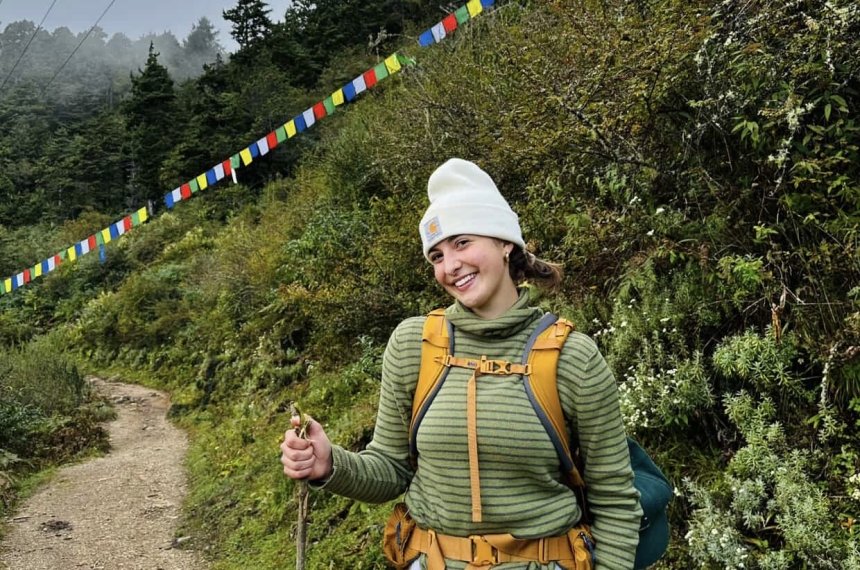 Sophia is taking a hike on a mountain.