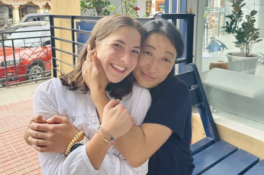 Sophia is posing and smiling with a friend.
