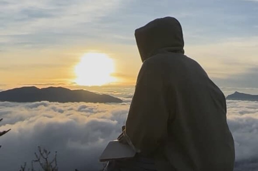 A view above the clouds in Bhutan as the sun is going down.