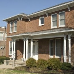 multi level brick home with steps leading up to porch