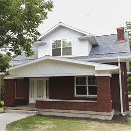 two story home with small porch brick 