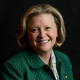 Person wearing green jacket smiling