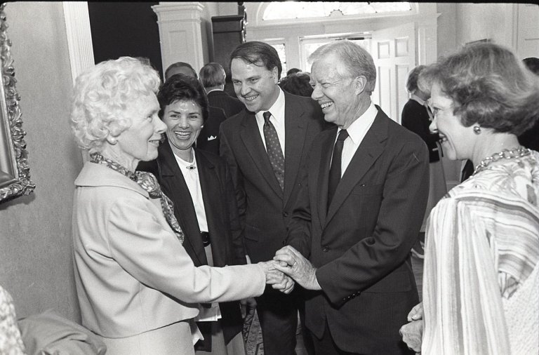 President Jimmy Carter shakes hands with a woman as he is surrounded by Centre College community members. 