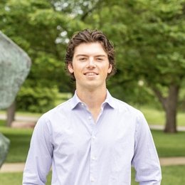 Guy with dark hair wearing light lavendar button up 