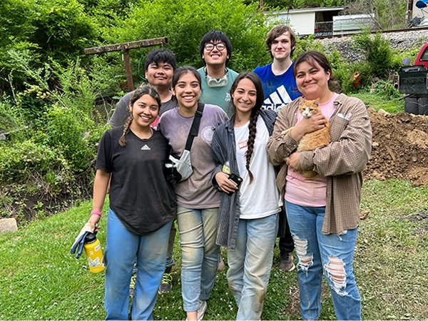 Group photo of students working on service project on site