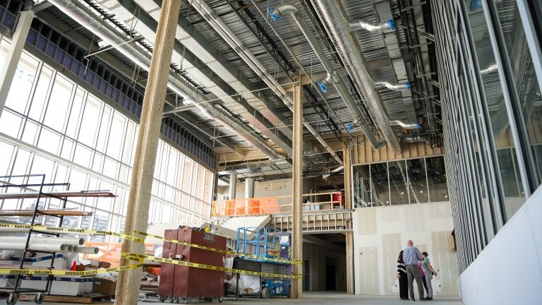 The metal framework of a building is seen from inside during construction.