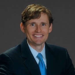 Person wearing suit smiling 