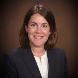 Person wearing suit jacket smiling