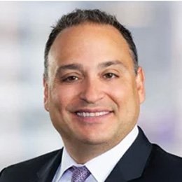 Person wearing suit smiling 