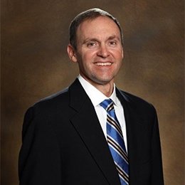 Person wearing suit smiling 