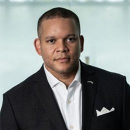 Person wearing black suit jacket and white button up shirt