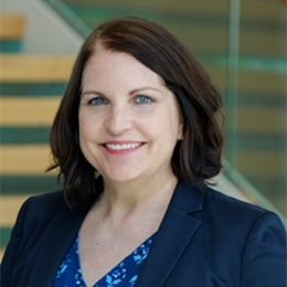 Person wearing suit and smiling 