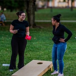 students playing corn hole