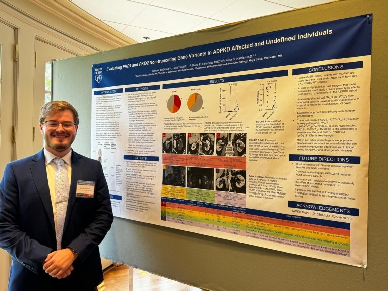 McGinnis standing in front of his poster presenting his research on Polycystic Kidney Disease.