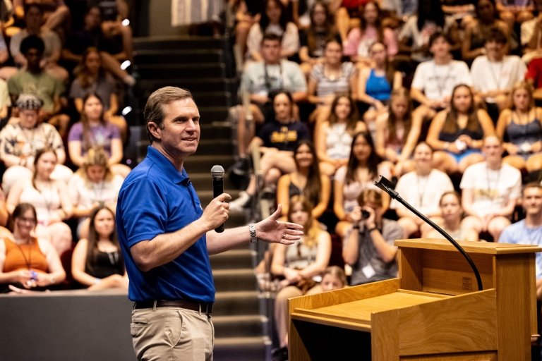 Andy Beshear speaks in front of a crowd of high school students.