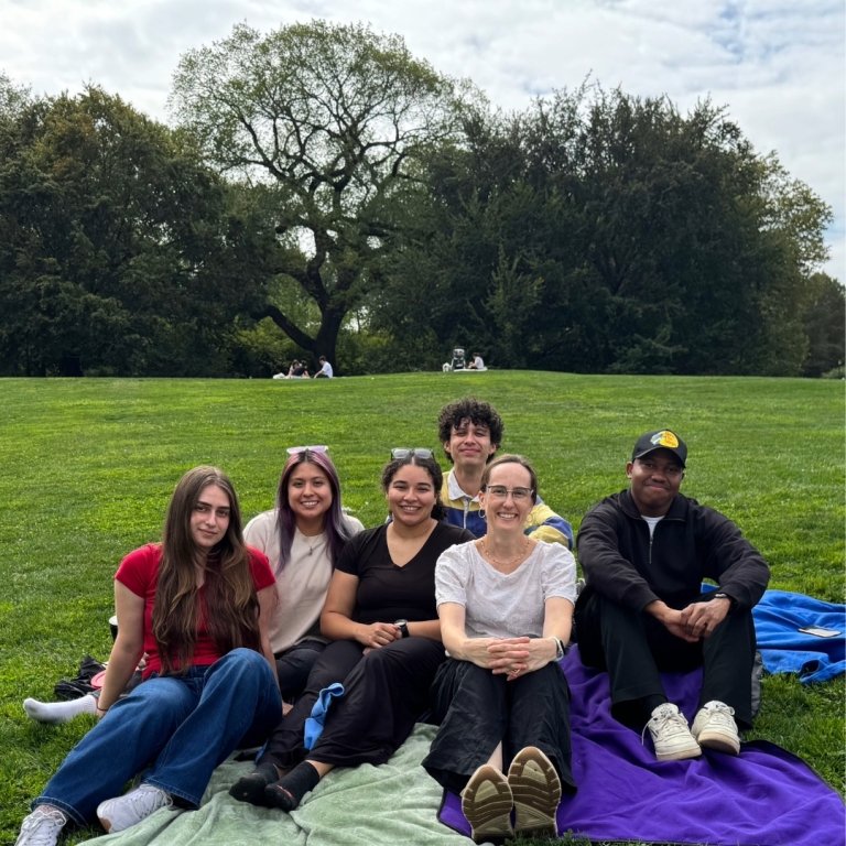 Anna is at the park with her lab supervisor and her lab peers.