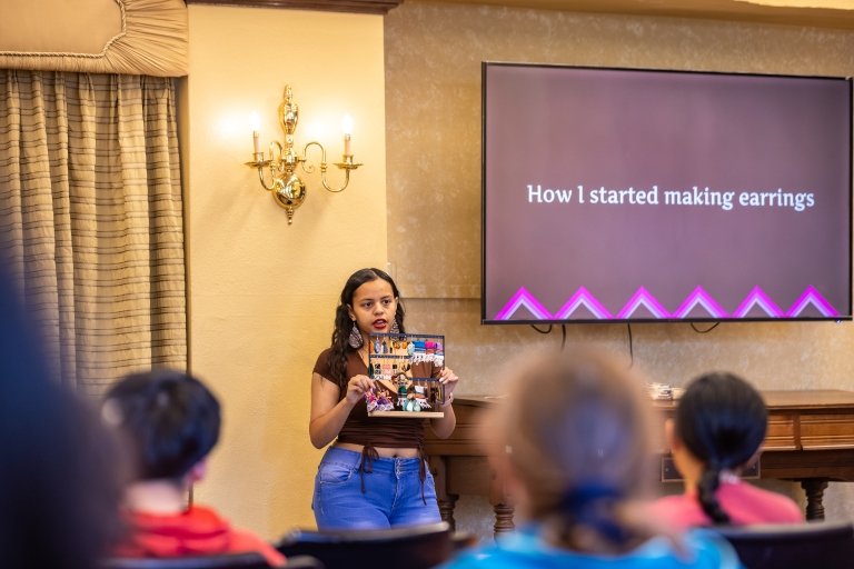 Ashley Flores shows off her handmade earrings