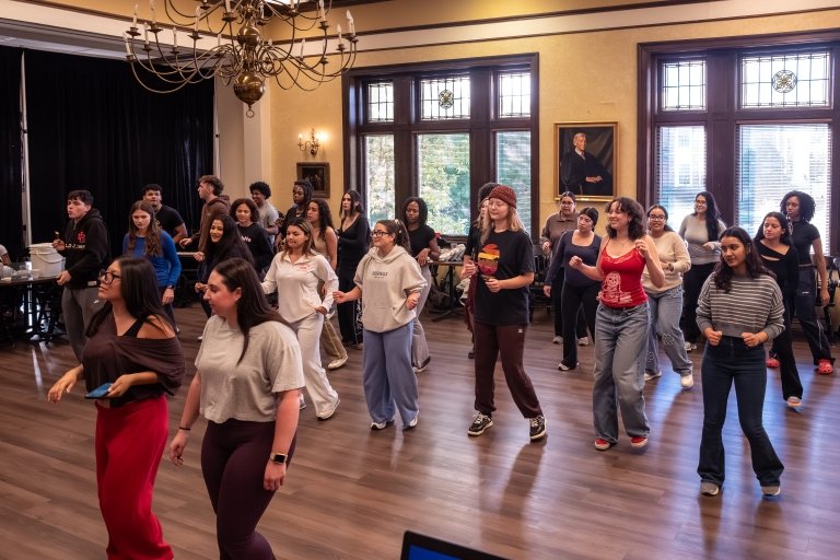 Students dance the bachata during Getza Solano's Building Bridges and Community session