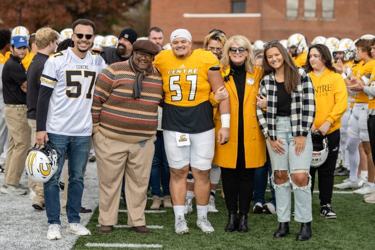 A Centre College football player stands with his family on senior day. 