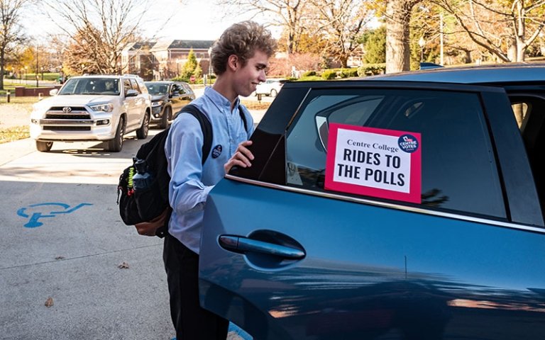 Student entering a car for ride to voting polls