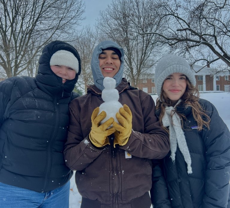 Cate Boyette and friends enjoy the snow of Centre's campus, showing off a snowman they made.