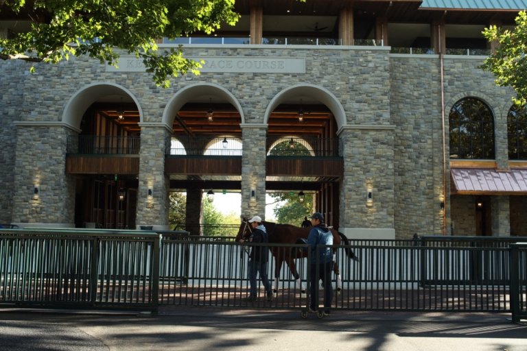 Centre College student Catesby Clay and another person a horse past the ornate stone paddocks at Keeneland racetrack in Lexington, Kentucky. 