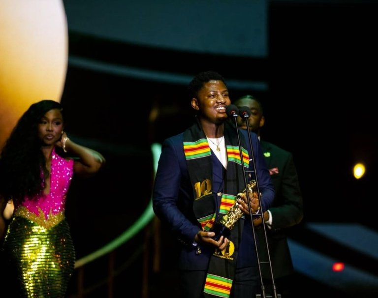 Fabris Mulindi on stage as he accepts his African Youth Changemaker award.