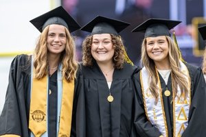 students dressed in graduation regalia
