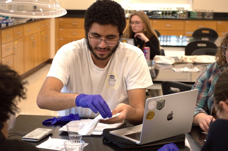 Adam Ibrahim conducts an experiment in the lab. 
