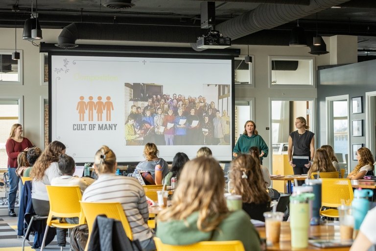 Students are presenting about a specific high-control group to the entire class.